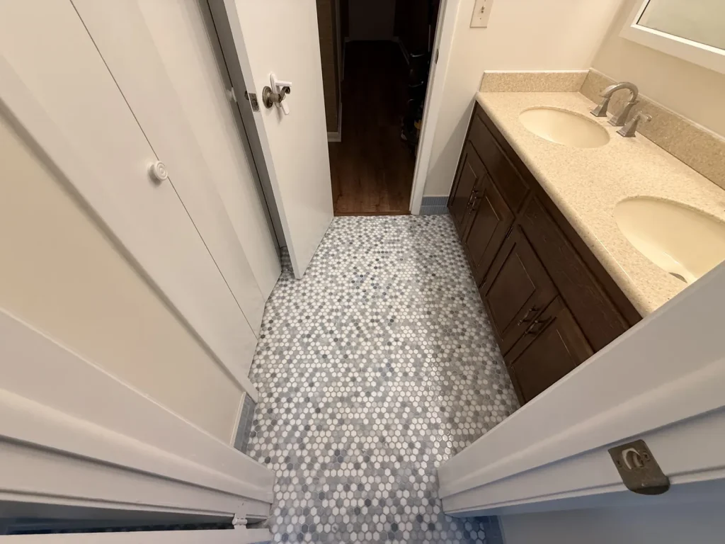 Pebble mosaic floor leading to vanity