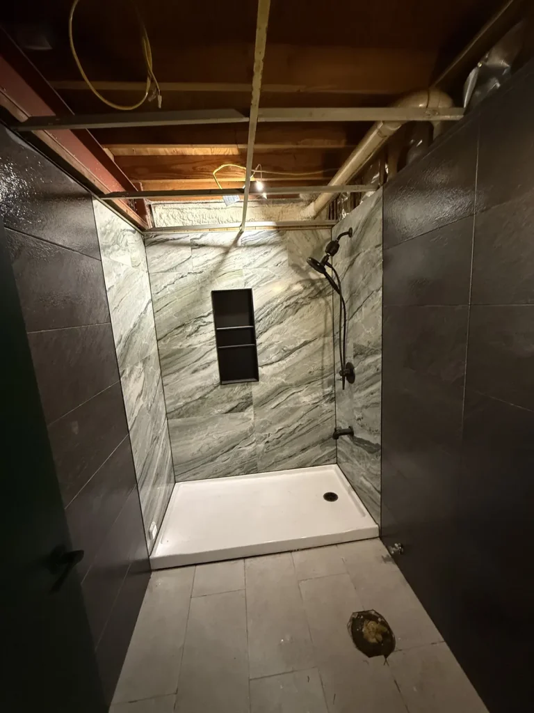 Marble-look walk-in shower with niche